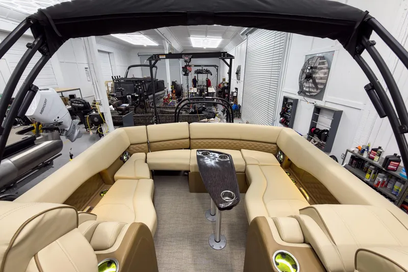 Slide: The Image of Luxurious 2026 Godfrey Sanpan 23' Ultra Lounge Tritoon interior with plush seating and table. - 34