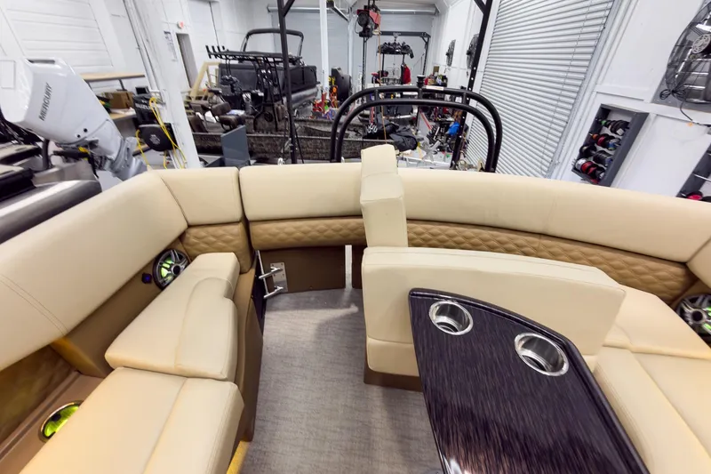 Slide: The Image of Luxurious interior of 2026 Godfrey Sanpan 23' Ultra Lounge Tritoon with plush seating and cup holders. - 38