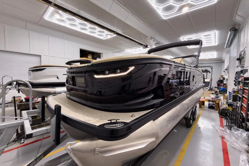 Slide: The Image of Godfrey Sanpan 23' Ultra Lounge Tritoon 2026 in workshop. - 4