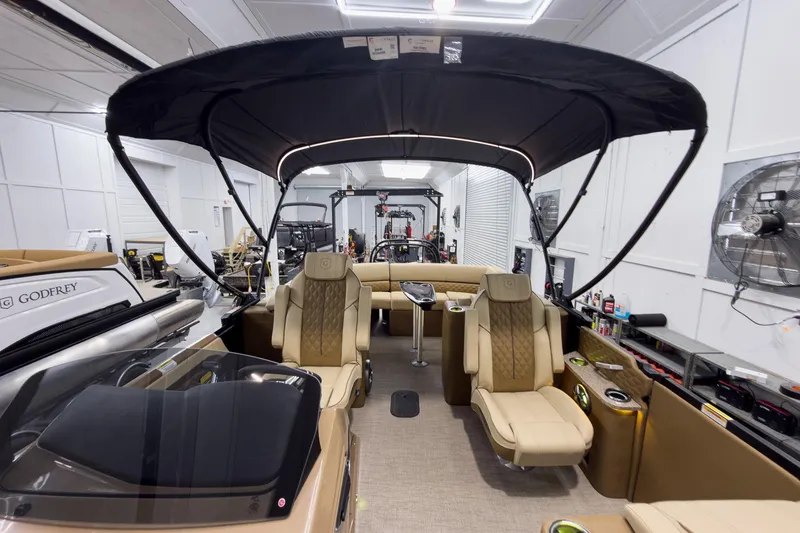 Slide: The Image of 2026 Godfrey Sanpan 23' Ultra Lounge Tritoon interior with luxurious seating and canopy. - 43