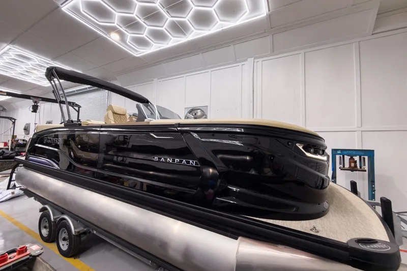 Slide: The Image of 2026 Godfrey Sanpan 23' Ultra Lounge Tritoon in showroom, showcasing sleek design and luxury features. - 9