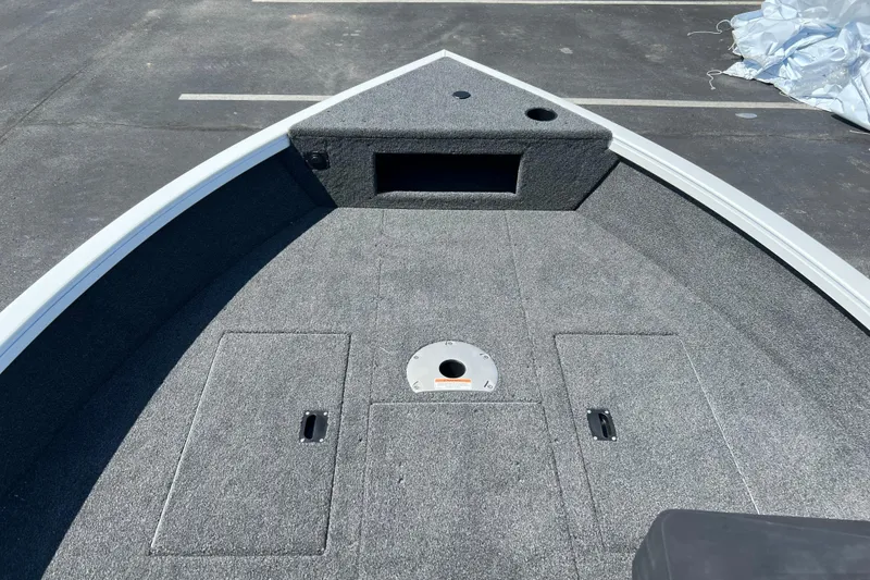 Slide: The Image of 2024 Crestliner 1650 HAWK SC boat deck with storage compartments and carpeted surface. - 3