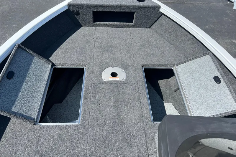 Slide: The Image of 2024 Crestliner 1650 HAWK SC boat deck with open storage compartments. - 5