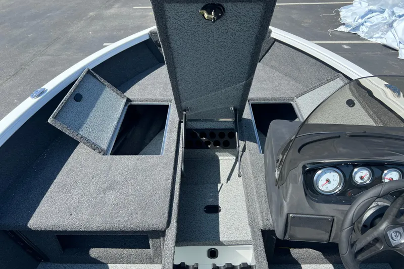 Slide: The Image of 2024 Crestliner 1650 HAWK SC boat interior with storage compartments and dashboard. - 6