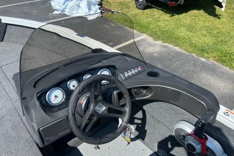 Slide: The Image of 2024 Crestliner 1650 HAWK SC boat dashboard with steering wheel and gauges. - 8