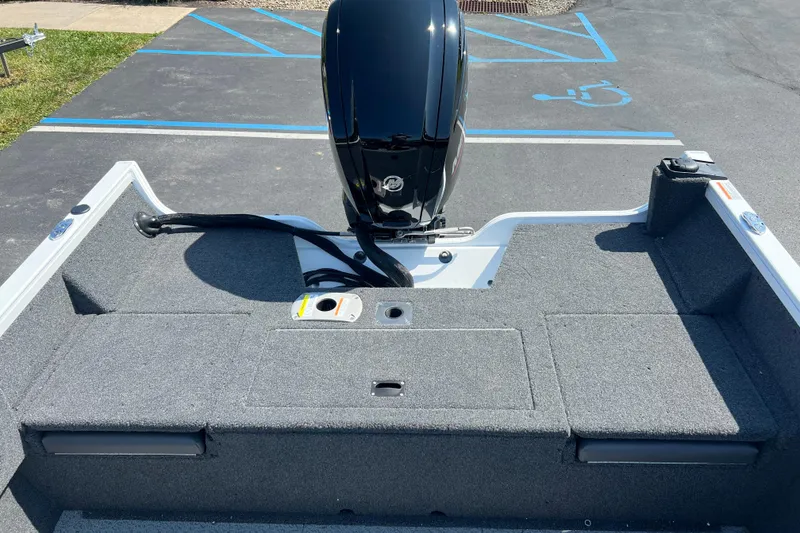 Slide: The Image of 2024 Crestliner 1650 HAWK SC boat with motor, carpeted deck, and parking lot background. - 9