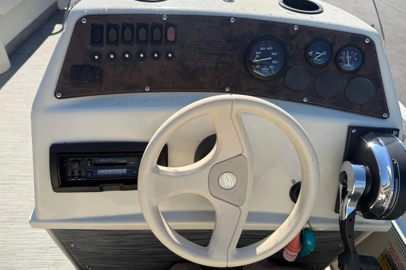 Slide: The Image of Steering console of a 1999 Bennington 208 L boat with gauges and controls. - 15