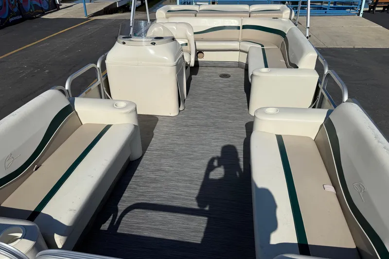 Slide: The Image of 1999 Bennington 208 L pontoon boat interior with seating and console. - 9