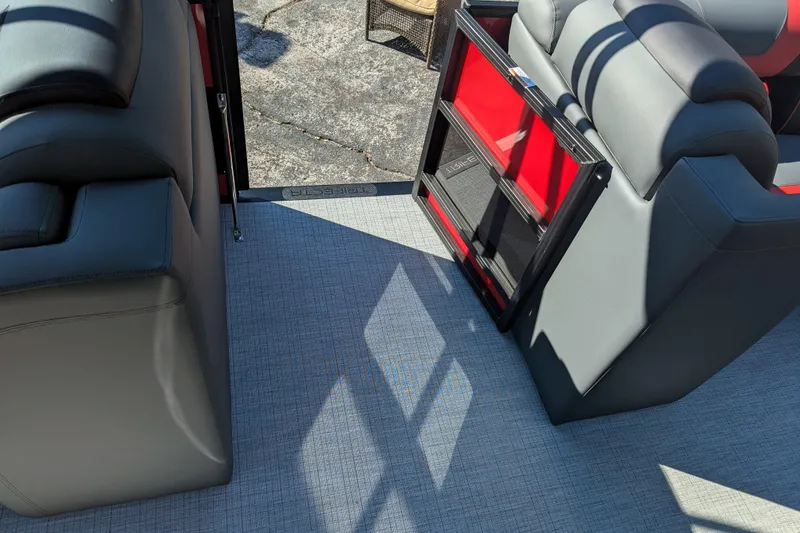 Slide: The Image of 2026 Trifecta 21C SS boat interior with gray and red seating, textured flooring. - 10