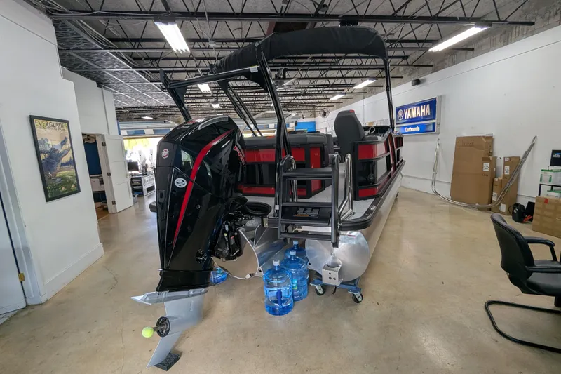 Slide: The Image of 2026 Trifecta 21C SS pontoon boat with outboard motor in showroom. - 23