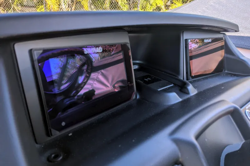 Slide: The Image of 2026 Trifecta 21C SS dashboard with dual Simrad displays, reflecting outdoor scenery. - 3