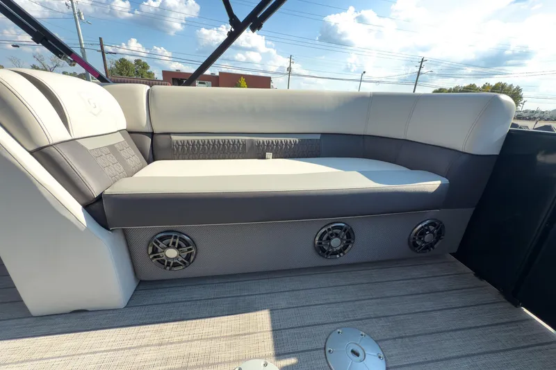 Slide: The Image of Luxurious seating on 2024 Godfrey Sweetwater 22' pontoon boat, featuring stylish design and speakers. - 16
