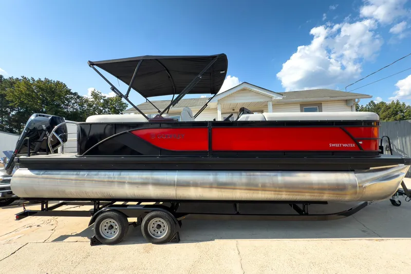 Slide: The Image of 2024 Godfrey Sweetwater 22' pontoon boat with Mercury 400 V10 engine, red and black design. - 2