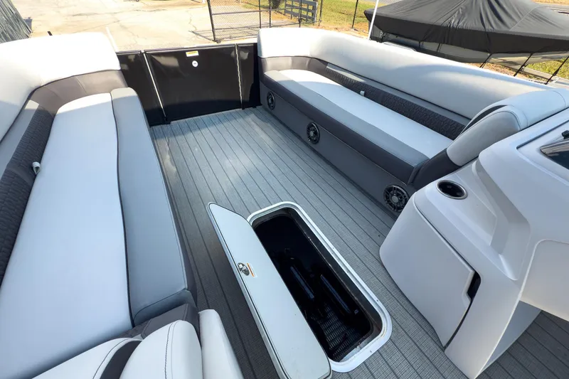 Slide: The Image of 2024 Godfrey Sweetwater 22' pontoon boat interior with split bench seating and storage compartment. - 22