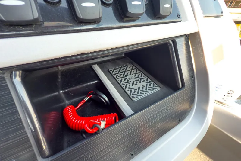 Slide: The Image of Control panel of 2024 Godfrey Sweetwater 22' boat with red safety lanyard. - 24