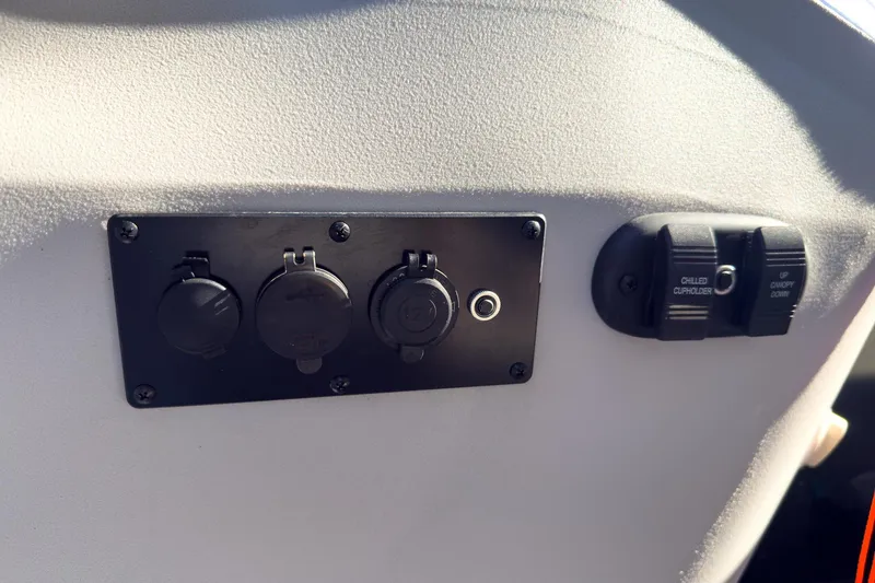 Slide: The Image of Control panel of 2024 Godfrey Sweetwater 22' boat with switches and outlets. - 25