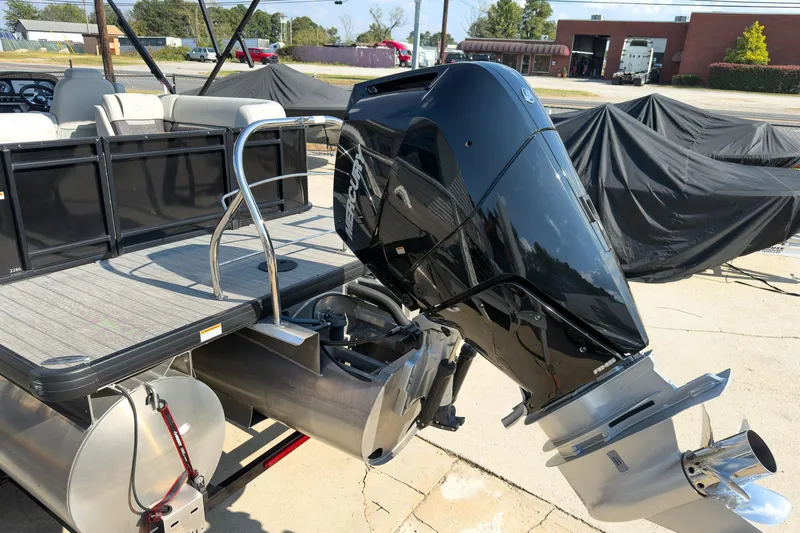 Slide: The Image of 2024 Godfrey Sweetwater 22' pontoon boat with Mercury 400 V10 engine, docked outdoors. - 28