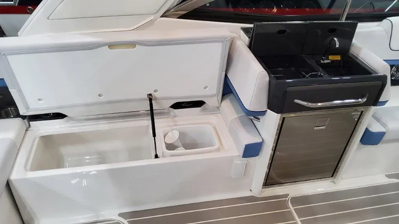 Slide: The Image of 2025 Formula 330 Crossover Bowrider OB interior with storage and kitchenette features. - 12