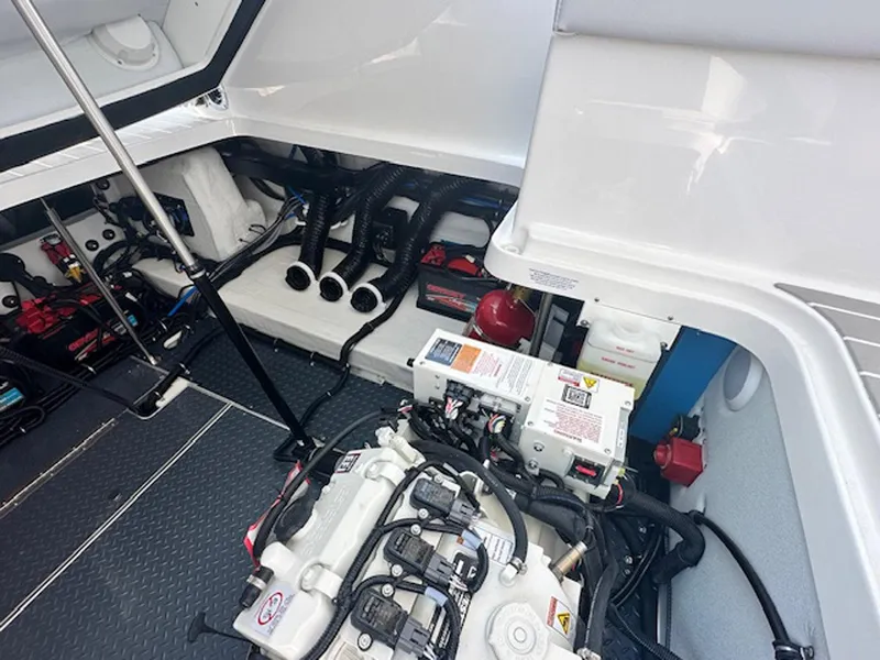 Slide: The Image of Engine compartment of 2025 Formula 330 Crossover Bowrider OB, showcasing mechanical components and wiring. - 21