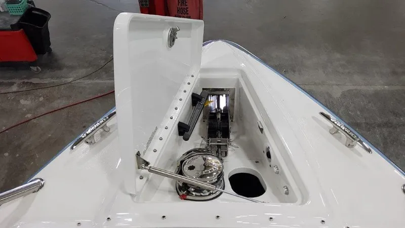 Slide: The Image of 2025 Formula 330 Crossover Bowrider OB anchor compartment with open hatch, showcasing marine equipment. - 3