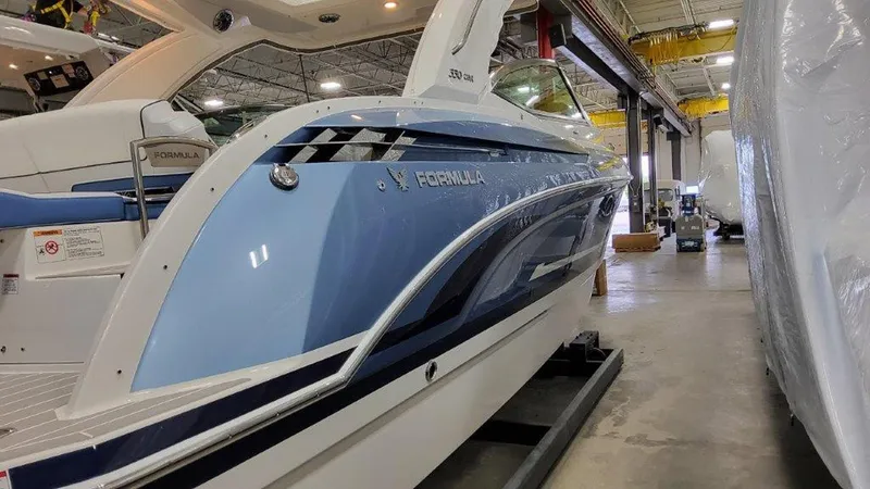 Slide: The Image of 2025 Formula 330 Crossover Bowrider OB in a showroom, showcasing sleek blue design. - 30
