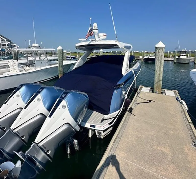 Slide: The Image of 2025 Formula 330 Crossover Bowrider OB docked with twin outboard engines, covered deck. - 32