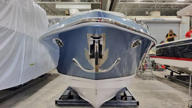 Slide: The Image of 2025 Formula 330 Crossover Bowrider OB in a showroom, front view. - 9