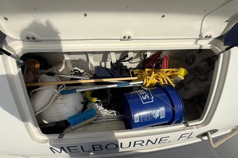 Slide: The Image of Storage compartment of a 2006 Sea Ray 48 Sundancer boat with cleaning supplies and equipment. - 108