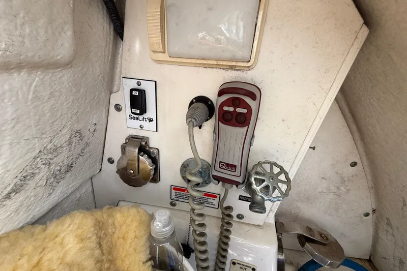 Slide: The Image of Control panel of a 2006 Sea Ray 48 Sundancer boat with various switches and controls. - 109