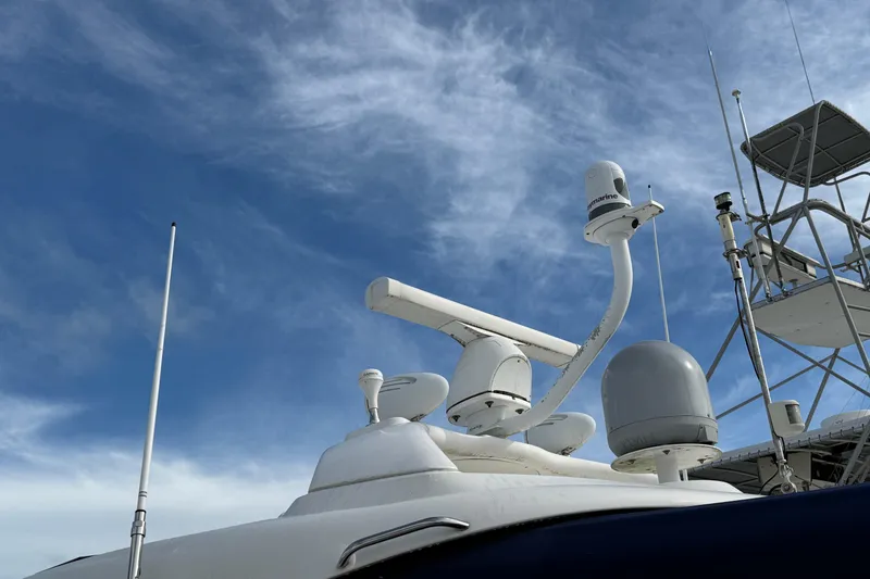 Slide: The Image of Radar and communication equipment on a 2006 Sea Ray 48 Sundancer against a blue sky. - 11