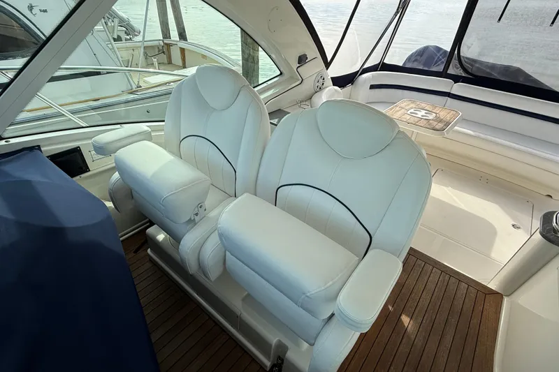 Slide: The Image of Luxurious interior of 2006 Sea Ray 48 Sundancer with plush white seating and wooden flooring. - 23
