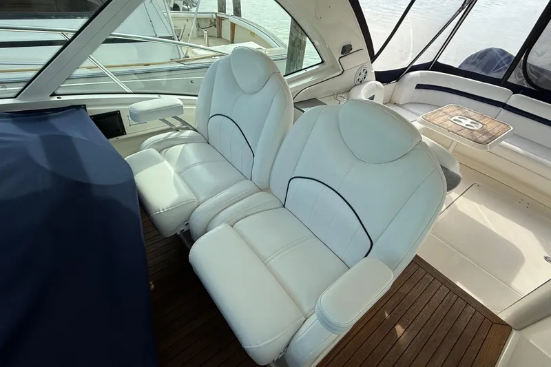 Slide: The Image of Luxurious interior of 2006 Sea Ray 48 Sundancer with white leather seating and wooden flooring. - 24