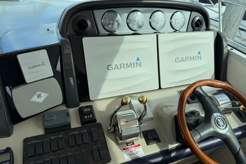 Slide: The Image of Helm of 2006 Sea Ray 48 Sundancer with Garmin navigation system and wooden steering wheel. - 28