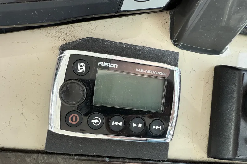 Slide: The Image of Fusion MS-NRX200i marine stereo remote on 2006 Sea Ray 48 Sundancer dashboard. - 34