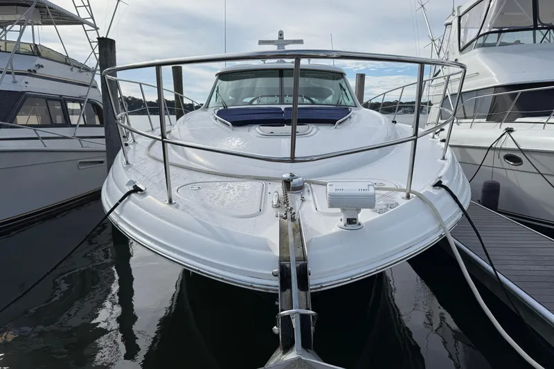 Slide: The Image of 2006 Sea Ray 48 Sundancer yacht docked, showcasing sleek design and spacious deck. - 5