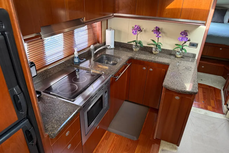 Slide: The Image of Luxurious kitchen interior of 2006 Sea Ray 48 Sundancer yacht with modern amenities. - 50