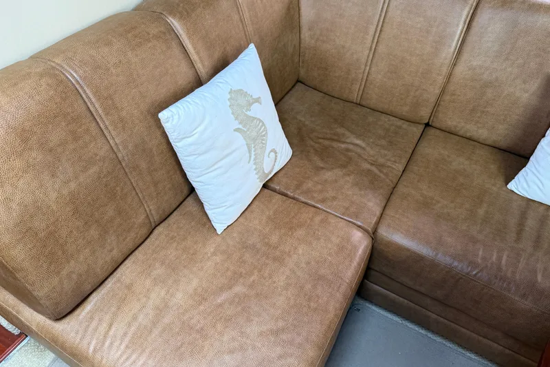 Slide: The Image of Brown leather seating with seahorse pillows on a 2006 Sea Ray 48 Sundancer yacht. - 53