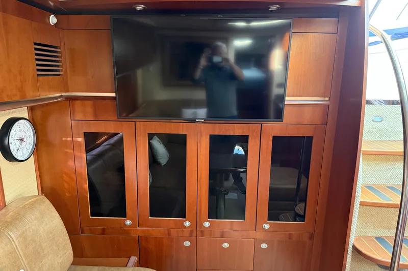 Slide: The Image of Interior of 2006 Sea Ray 48 Sundancer with TV, wooden cabinets, and clock. - 55