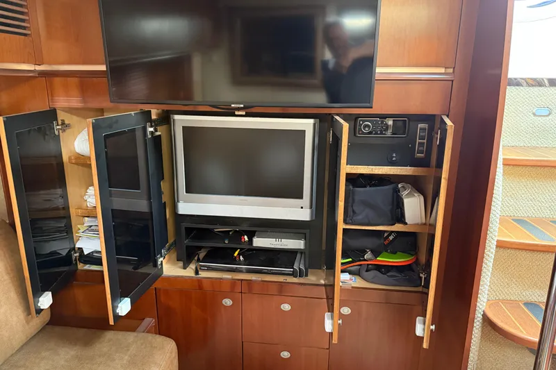 Slide: The Image of Entertainment center on 2006 Sea Ray 48 Sundancer yacht with TV and storage cabinets. - 57