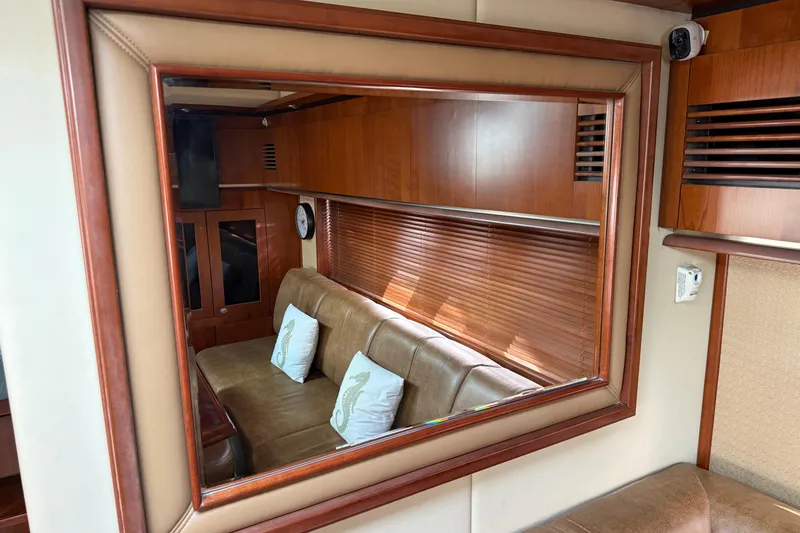 Slide: The Image of Luxurious interior of 2006 Sea Ray 48 Sundancer yacht with leather seating and wooden accents. - 58