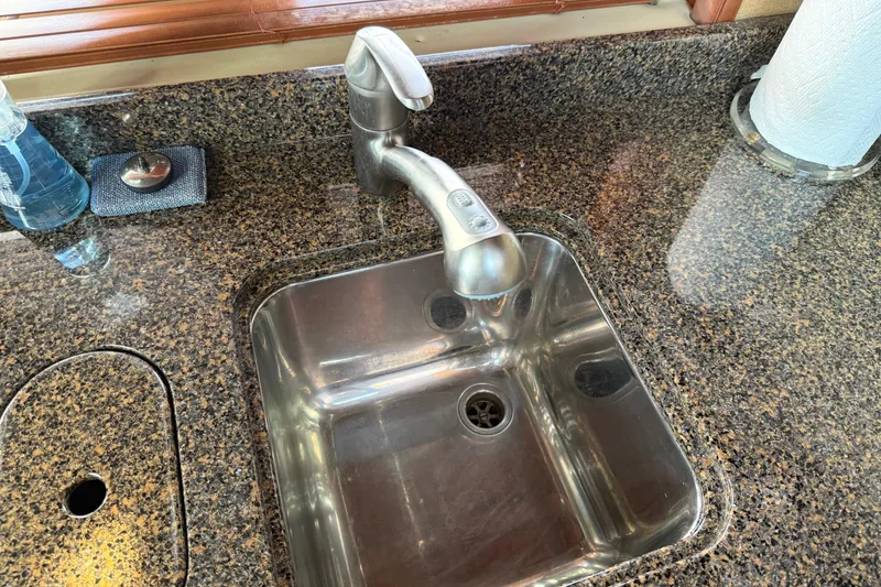 Slide: The Image of Stainless steel sink and faucet on Sea Ray 48 Sundancer 2006 yacht kitchen countertop. - 64