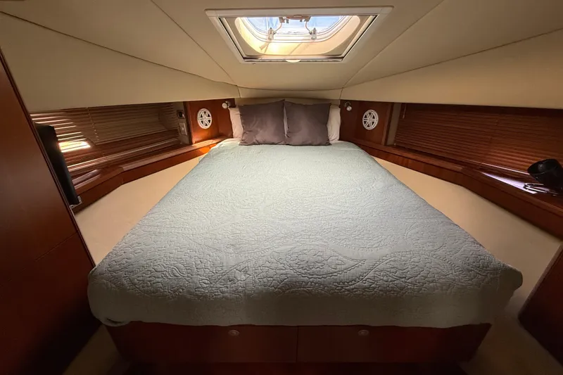 Slide: The Image of Luxurious cabin interior of 2006 Sea Ray 48 Sundancer yacht with skylight and cozy bedding. - 67