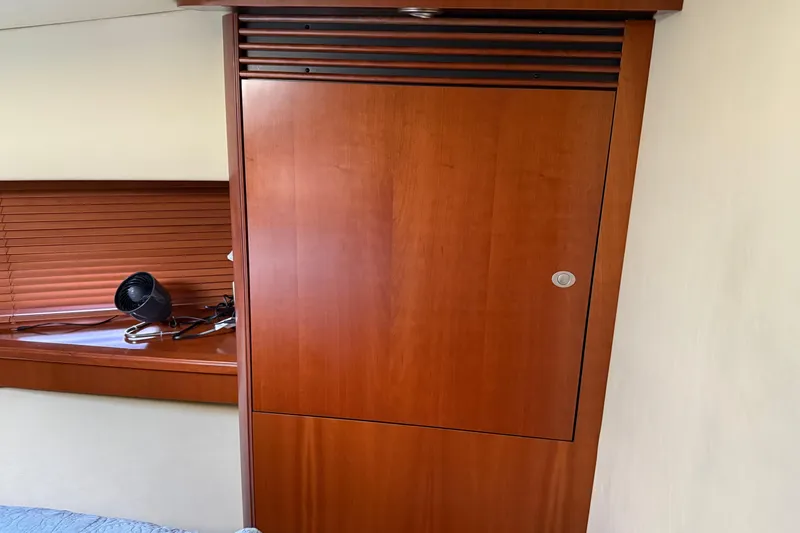 Slide: The Image of Interior of 2006 Sea Ray 48 Sundancer with wooden cabinet and window blinds. - 68