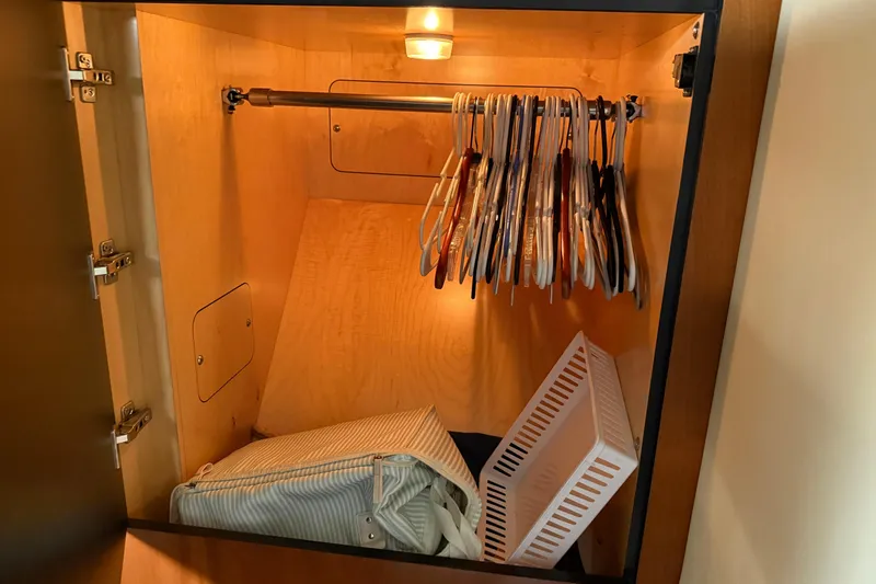 Slide: The Image of Wooden closet with hangers and storage in 2006 Sea Ray 48 Sundancer yacht. - 69