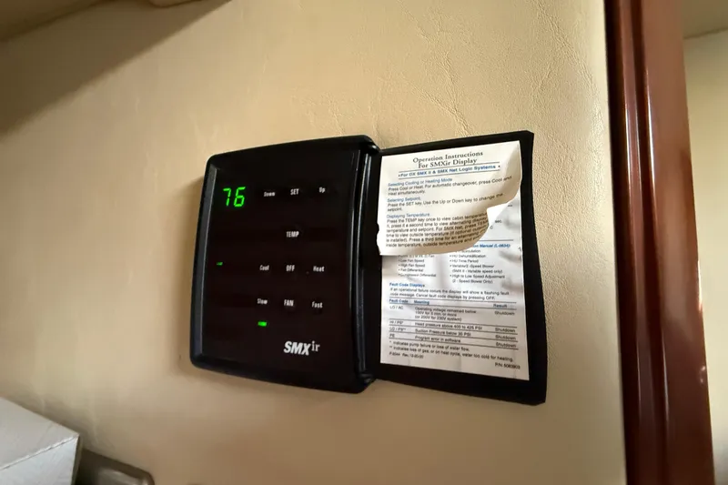 Slide: The Image of SMXir thermostat display in 2006 Sea Ray 48 Sundancer yacht, showing temperature and instructions. - 74