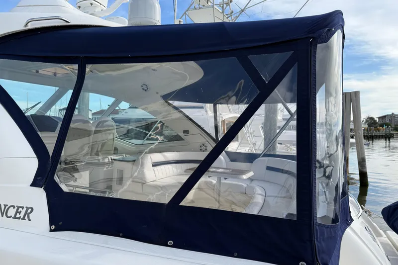 Slide: The Image of 2006 Sea Ray 48 Sundancer yacht with enclosed cockpit, docked at marina. - 8