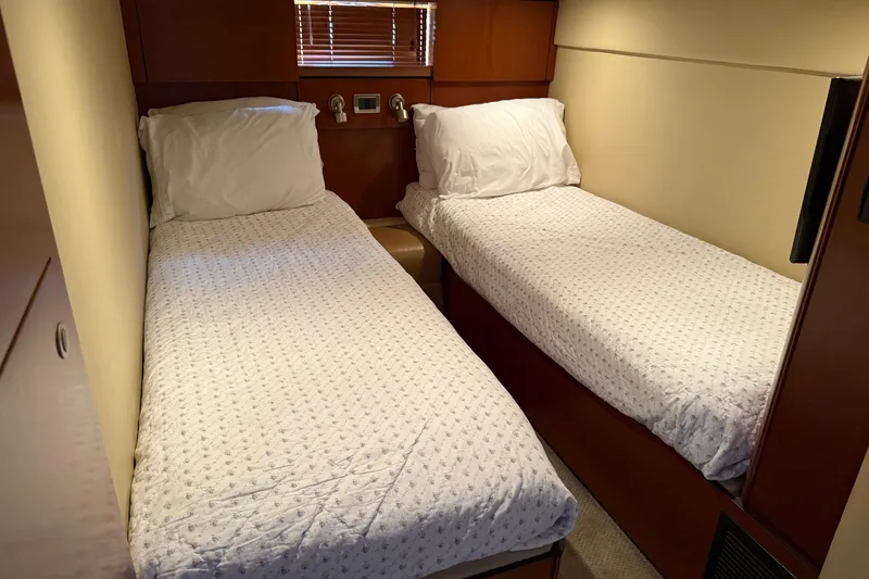 Slide: The Image of Twin beds in the cabin of a 2006 Sea Ray 48 Sundancer yacht. - 82