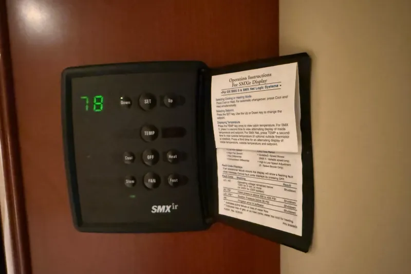 Slide: The Image of Thermostat control panel on a 2006 Sea Ray 48 Sundancer yacht, displaying temperature settings. - 90