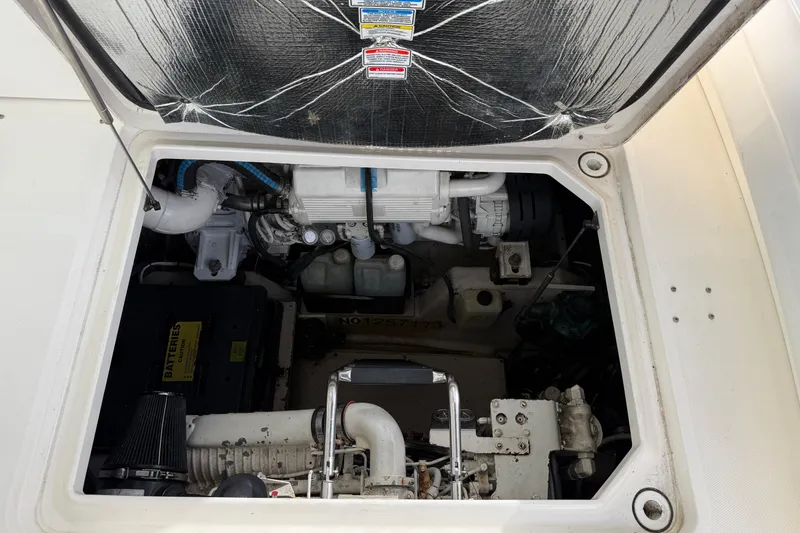 Slide: The Image of Engine compartment of a 2006 Sea Ray 48 Sundancer boat, showing mechanical components. - 94