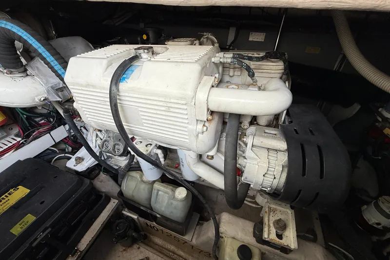 Slide: The Image of Engine compartment of a 2006 Sea Ray 48 Sundancer yacht, showcasing mechanical components. - 95